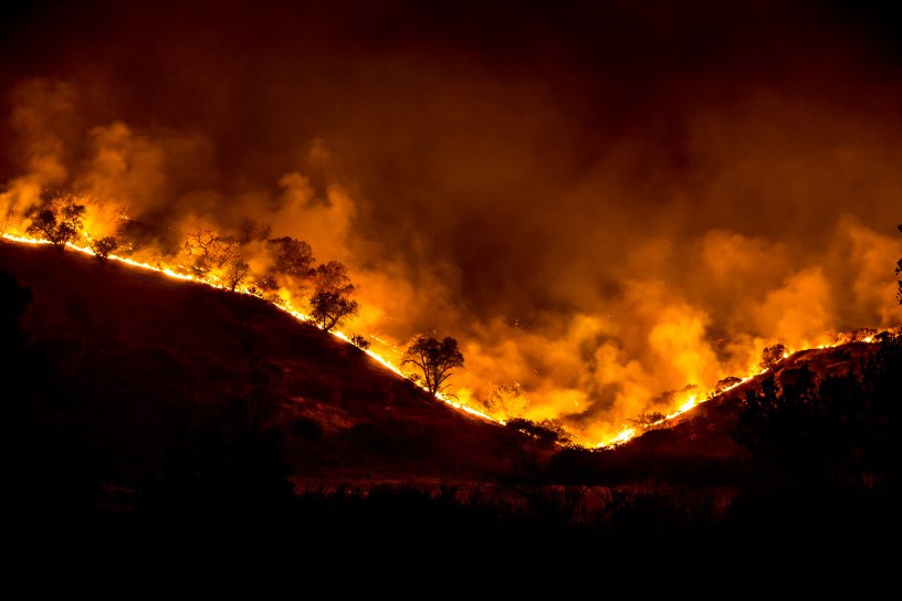 A thumbnail of a wild brush fire occurring at night that provides more information on the topic Drought-related wildfire risk 